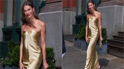 Karlie Kloss dazzled in a liquid gold strapless Tove Fall 2026 gown, styling it with silver sandals, a champagne satin clutch and a bold red lip. (Instagram)
