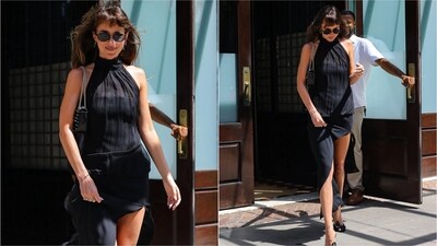 Dakota Johnson opted for understated elegance in a black asymmetrical gown, accessorising with a sleek black handbag and minimal jewellery. (Instagram)