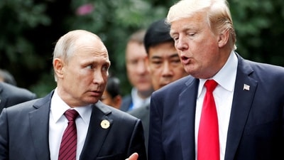 President Donald Trump and Russia's President Vladimir Putin talk during the family photo session at the APEC Summit in Danang (File photo/REUTERS)