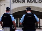 The woman was arrested at the police station and charged with murder and domestic violence on Sunday. 