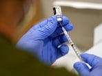 FILE - A healthcare worker fills a syringe with the Pfizer COVID-19 vaccine at Jackson Memorial Hospital on Oct. 5, 2021, in Miami. VAIDS is not a real condition, experts say. The co-authors of the study say their work is being misrepresented and doesn’t show that the vaccine is harmful to the immune system. The false claim is spreading as U.S. health officials recommend most Americans receive an updated COVID-19 vaccine. (AP Photo/Lynne Sladky, File)(AP)
