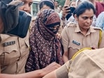 File photo of police personnel escorting Nida Khan, the prime accused in the TCS Nashik case involving alleged sexual harassment and forced religious conversions, at the Additional Sessions Court in Nashik Road.