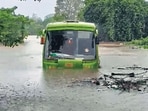 Raigad [Maharashtra], Jul 05 (ANI): A vehicle moves in a waterlogged area during heavy rainfall, in Raigad on Sunday. (ANI Video Grab) (ANI Video Grab)