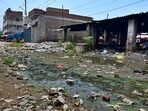 Sewage water, heap of garbage lying on the road in Nanak Nagar in Ludhiana on Monday. (Gurpreet Singh/HT)