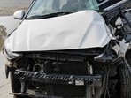 The impact crushed the Hyundai Aura, trapping all five occupants inside until commuters rescued them and alerted police. (HT)