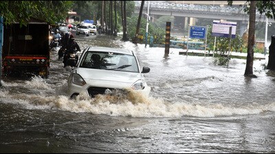 A young man was swept away by strong floodwaters while attempting to push his motorcycle across a waterlogged road in Khed taluka on Sunday. (MAHENDRA KOLHE/HT PHOTO)