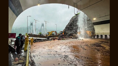 Rescue personnel carry out operations with the help of earthmovers after heavy rainfall triggered a landslide near the Missing Link section of the Pune-Mumbai Expressway, in Maharashtra. (Handout)