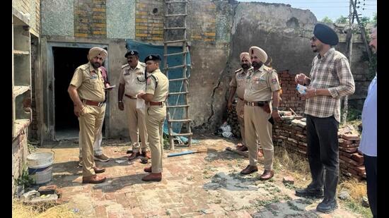 Police officials at the crime scene in in Daroli Kalan village of Jalandhar district on Monday.