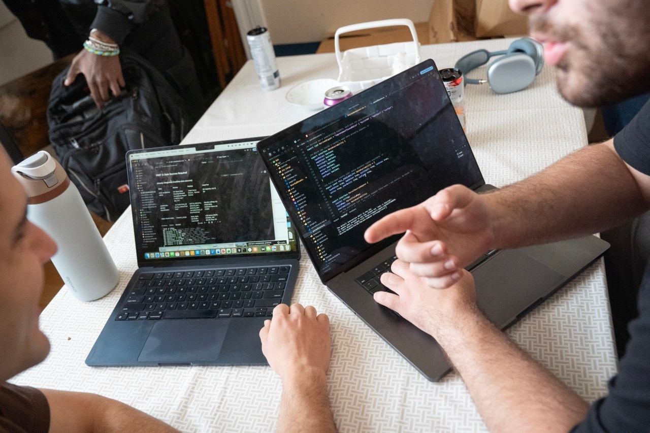 Lucas Santos and Nicolas Gertler reviewing code.