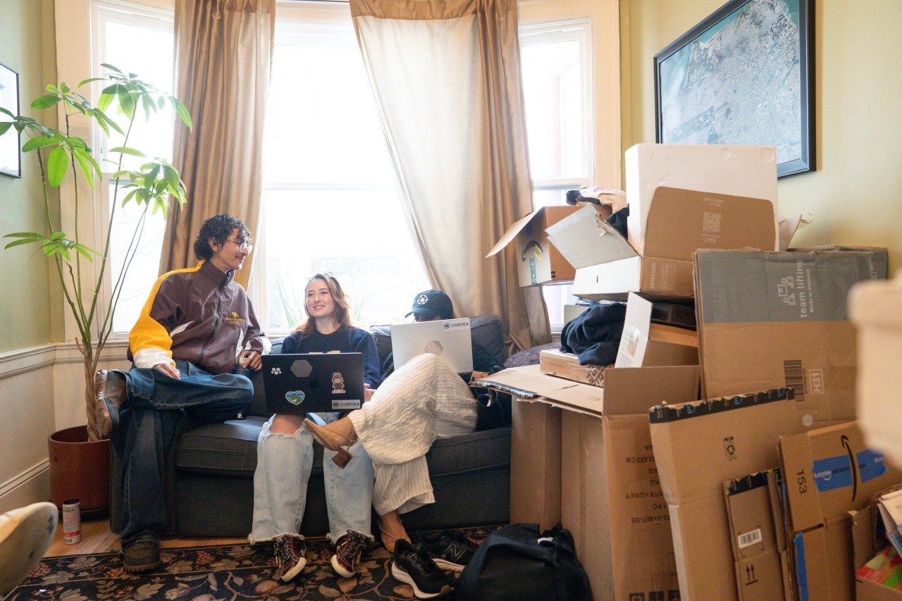 The members of the Yale Hacker House share a space crowded with cardboard boxes from hardware purchases.