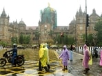 People walk through the heavy Rain at CSMT, in Mumbai.
