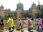 People walk through the heavy Rain at CSMT in Mumbai on Monday.