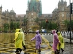 People walk through the heavy Rain at CSMT, in Mumbai.
