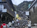 A landslide triggered by incessant rainfall damaged houses and left boulders strewn across a residential area in Thathri town of Doda district on Tuesday. (PTI Photo)
