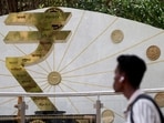 FILE PHOTO: A man walks past an installation of the Rupee logo and Indian currency coins outside the Reserve Bank of India (RBI) headquarters in Mumbai, India, April 9, 2025. (REUTERS)