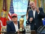 US President Donald Trump joined by FIFA president Gianni Infantino (R) holds the World Cup Trophy as he makes an announcement in the Oval Office of the White House in Washington, DC, on August 22, 2025