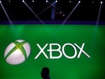 FILE - A man walks past the Xbox logo at the Microsoft booth during the E3 game show in Los Angeles, Tuesday, June 11, 2013. (AP Photo/Jae C. Hong, File)