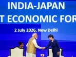 Prime Minister Narendra Modi greets Japanese Prime Minister Sanae Takaichi during the India-Japan Joint Economic Forum, in New Delhi.