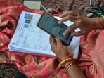 A Booth Level Officer (BLO) verifies voter details during the Special Intensive Revision (SIR) of electoral rolls.