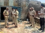 Police officials at the crime scene in in Daroli Kalan village of Jalandhar district on Monday.