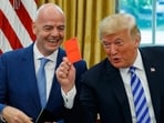 President Donald Trump holds up a red card during a meeting with FIFA president Gianni Infantino in the Oval Office of the White House (Evan Vucci)