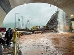 Rescue personnel carry out operations with the help of earthmovers after heavy rainfall triggered a landslide near the Missing Link section of the Pune-Mumbai Expressway, in Maharashtra. (Handout)