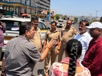 Traffic police at the Abhinav School–Navale Bridge stretch while listening to feedback from locals. (HT)
