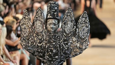 A sculptural headpiece inspired by ancient Hindu deity carvings set the tone for Rahul Mishra's Devi collection, celebrating mythology through haute couture. (AFP)