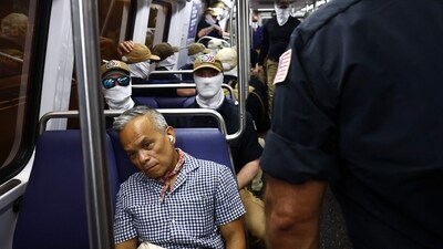 WASHINGTON, DC - JULY 04: Roswell Encina looks on as members of the white supremacist group Patriot Front ride the Washington Metro during Fourth of July celebrations on July 04, 2026 in Washington, DC. (Photo by Finn Gomez / GETTY IMAGES NORTH AMERICA / Getty Images via AFP) (Getty Images via AFP) WASHINGTON, DC - JULY 04: Roswell Encina looks on as members of the white supremacist group Patriot Front ride the Washington Metro during Fourth of July celebrations on July 04, 2026 in Washington, DC. (Photo by Finn Gomez / GETTY IMAGES NORTH AMERICA / Getty Images via AFP) (Getty Images via AFP)