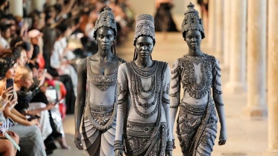 Models transformed into living stone sculptures walked the runway in intricately embroidered ensembles inspired by centuries-old Devi idols and temple carvings.(AFP)