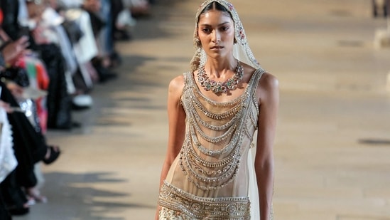 US model Pritika Swarup dazzled in Rahul Mishra's sheer embellished gown, topped with a dramatic net veil.(AFP)