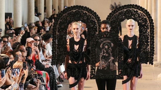 Shrine-inspired sculptural installations, paying homage to the divine feminine, set the stage for Rahul Mishra's Devi couture collection.(AFP)