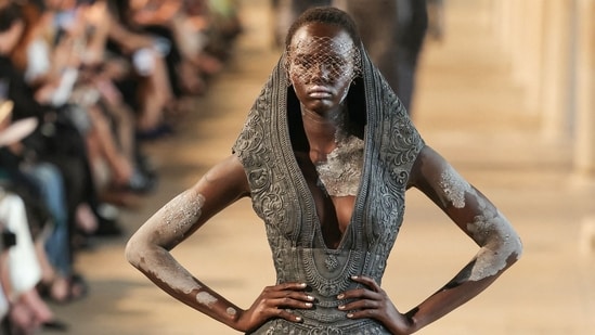 Intricate embroidery, sculpted draping and stone-textured body paint blurred the lines between fashion, art and ancient sculpture.(AFP)
