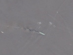 A satellite image shows a group of small boats near the Strait of Hormuz.