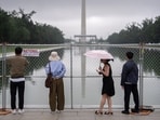 Visitors look at the Lincoln Memorial Reflecting Pool, July 7, 2026, in Washington.