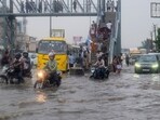 Commuters wade through a severely waterlogged road following heavy rainfall, in Gurugram, Haryana, Tuesday, July 7, 2026.