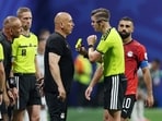 Egypt coach Hossam Hassan is shown a yellow card by referee Francois Letexier