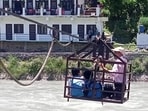 They walk nearly 2 km from their villages to the riverbank before being ferried across the swollen river by their parents using the trolley They walk nearly 2 km from their villages to the riverbank before being ferried across the swollen river by their parents using the trolley