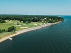 The club says the wall is needed to keep its signature hole from slipping into the sea.