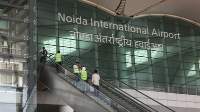 People stand on an escalator as they enter Noida International Airport (NIA), in Noida. (REUTERS)