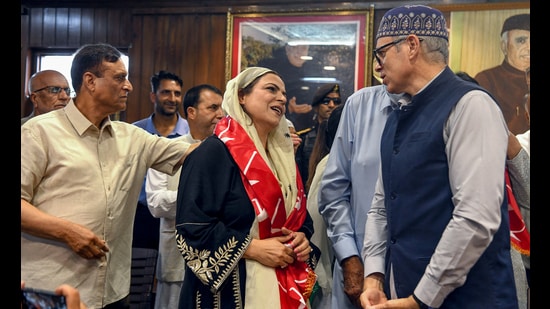 Ex-District Development Council (DDC) chairperson Baramulla Safina Baig interacts with Jammu and Kashmir CM Omar Abdullah at the National Conference headquarters in Srinagar on Wednesday. (ANI)