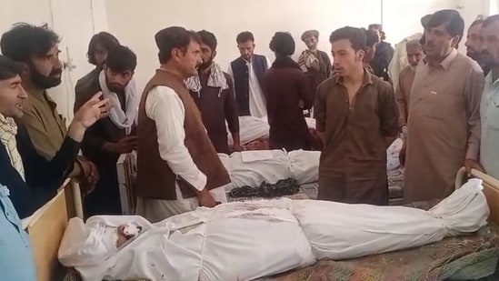Relatives gather around the body of a slain policeman at a hospital in Ziarat, in Balochistan province on July 7, 2026. (AFP)