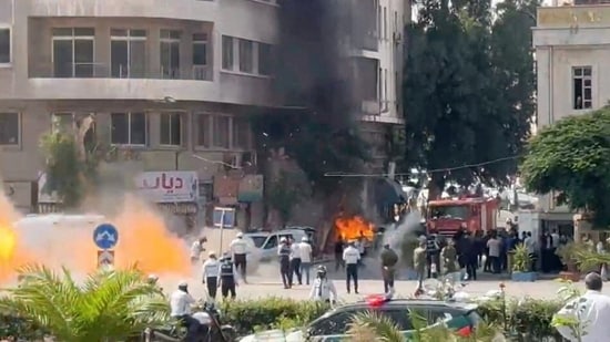 Emergency personnel work as smoke and fire rise at the site where explosive devices blew up near a hotel where French President Emmanuel Macron was meant to be staying, in Damascus, Syria, in this screengrab obtained from a video, July 7, 2026. (REUTERS)