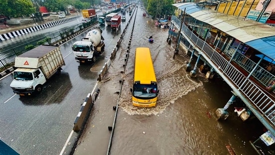 Vehicles wade through a waterlogged stretch amid heavy rain on the NH-48 service road near Narsinghpur village in Gurugram. (Parveen Kumar/ HT Photo)