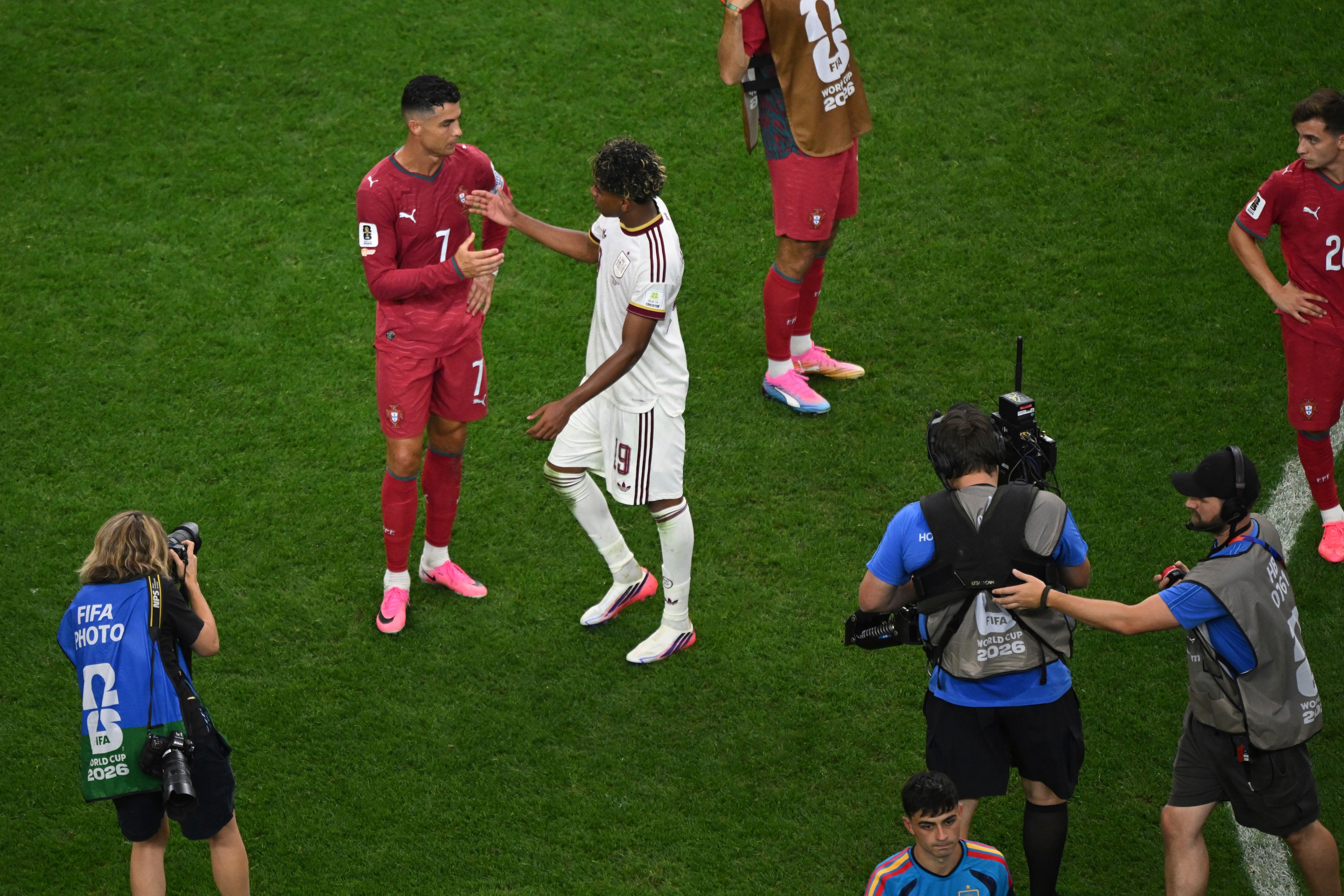Portugal's Cristiano Ronaldo (7) shakes hand with Spain's Lamine Yamal (19) after the end of the World Cup round of 16 soccer match between Portugal and Spain (AP Photo/Jessica Tobias)