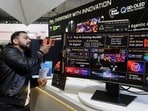 A visitor takes photo of a True AI Gaming Monitor at the Computex Taipei exhibition in Taiwan on June 2. (AP)