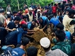 Rohingya refugees works to rescue victims from a landslide spot at a Rohingya Refugee Camp following continuous torrential rain, in Cox’s Bazar, Bangladesh.