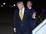 US President Donald Trump disembarks from Air Force One.