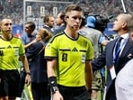 Referee Francois Letexier, of France, leaves the pitch after the World Cup round of 16 soccer match between Argentina and Egypt in Atlanta