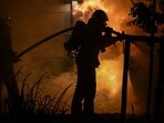 Menifee Bluff Fire map, evacuation updates: Videos show blaze near homes.(Photo by Gabriel BOUYS / AFP)
